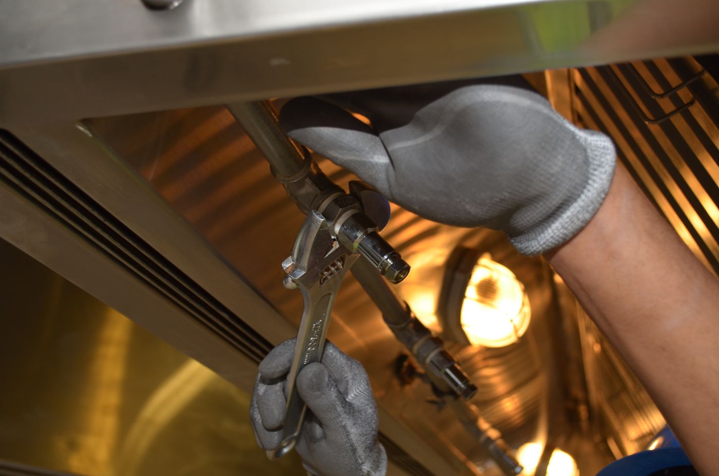 A plumber working on household plumbing